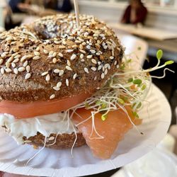 Bodo's Bagels - Lox and cream cheese with a tomato and sprouts on an everything wheat bagel
