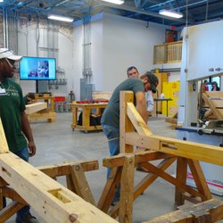 American College of Building Arts - Timber-framers working on raising a sign rack