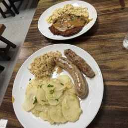 Bratwurst plate with sauerkraut and potato salad. Jägerschnitzel with handmade Spätzle. Bratwurst plate with sauerkraut and potato salad. Jägerschnitzel with handmade Spätzle.