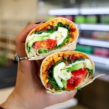 Beyond Juicery + Eatery - a hand holding a sandwich - Juice Bars & Smoothies Near Me - Ferndale, Michigan