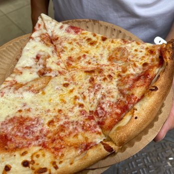 2 Bros Pizza - a slice of cheese pizza on a paper plate - Pizza Near Me - New York, New York