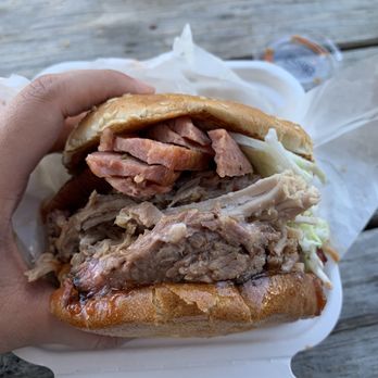 All Smoked Out BBQ - a person holding a sandwich - Barbeque Near Me - Medford, Oregon All Smoked Out BBQ - a person holding a sandwich - Barbeque Near Me - Medford, Oregon