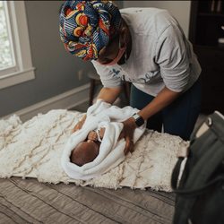 EVE Birth Services - Eve caring for newborn baby. Postpartum Doula. Photo by: Carmen Bridgewater