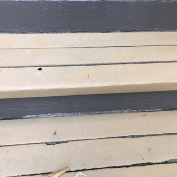 Unique Painting & Design - This is the "After" photo of the front steps: notice the sloppy horizontal stringers, color showing through, and the yellow. Originally red! - Painters Near Me