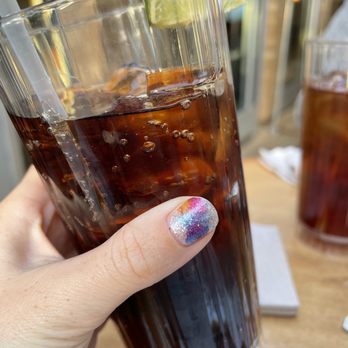 Paesanos - a person holding a glass of soda - Italian Near Me - Davis, California