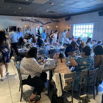 Plateia Mediterranean Kitchen Bar - Diverse family members waiting to be served dinner ... Opppaaa - Bars Near Me - Glenview, Illinois