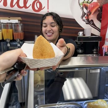 Brazilian Eats & Treats - Beautiful girl at counter handing me my coxinha of the day (My favorite) - Bakeries Near Me - Charlotte, North Carolina Brazilian Eats & Treats - Beautiful girl at counter handing me my coxinha of the day (My favorite) - Bakeries Near Me - Charlotte, North Carolina