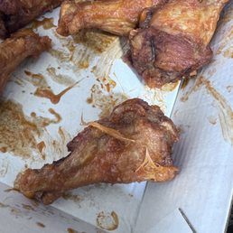 Chicken wing with feathers on it.