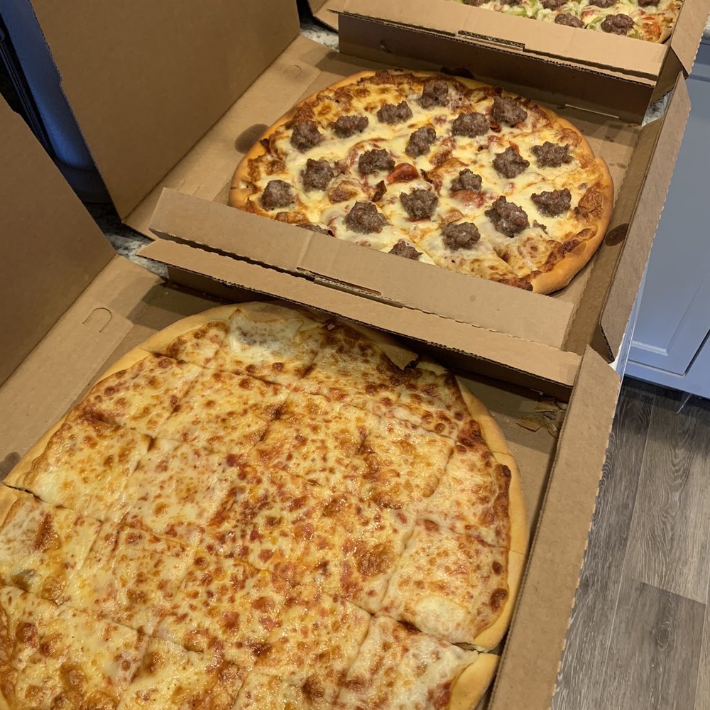 three pizzas in boxes