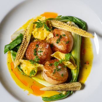 Rustic Root - PAN ROASTED SCALLOPS 

creamed corn agnolotti, sweet corn nage, fennel pollen, 'nduja oil - Cocktail Bars Near Me - San Diego, California