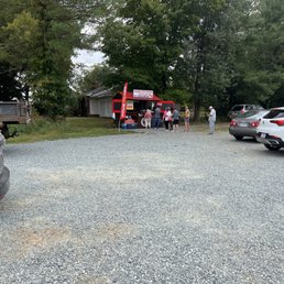 a parking lot with cars and people a parking lot with cars and people