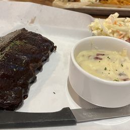 Half rack of ribs with mashed potatoes and coleslaw.