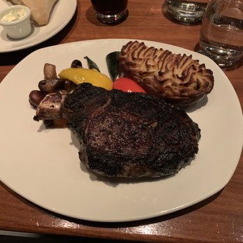 The Keg Steakhouse + Bar - 20oz Rib Steak-Chicago style and med rare with twice baked potato - Seafood Near Me - Pointe-Claire, Quebec The Keg Steakhouse + Bar - 20oz Rib Steak-Chicago style and med rare with twice baked potato - Seafood Near Me - Pointe-Claire, Quebec