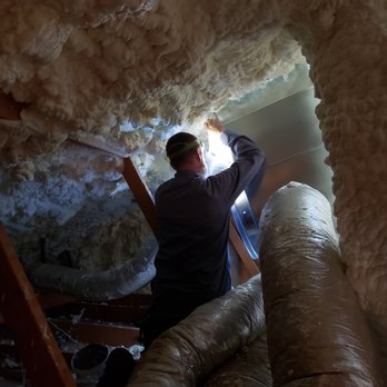 Evans Air Conditioning & Heating - Brian attaching ducting to the plenum. - Heating & Air Conditioning/HVAC Near Me
