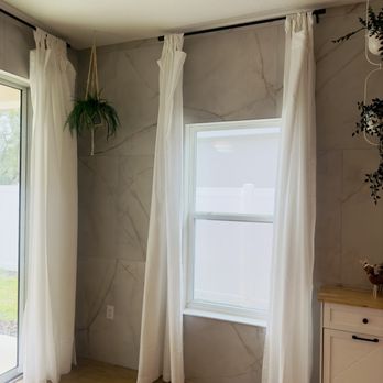 Orlando Flooring Gurus - a living room with white curtains - Flooring Near Me Orlando Flooring Gurus - a living room with white curtains - Flooring Near Me