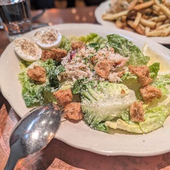 The Pink Door - Dungeness crab on Caesar salad - Italian Near Me - Seattle, Washington The Pink Door - Dungeness crab on Caesar salad - Italian Near Me - Seattle, Washington