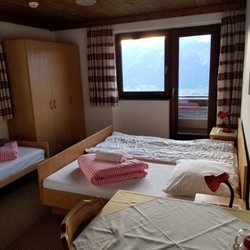 Gasthaus Windegg - Guest room with a king and single bed, and a balcony with an amazing view looking down on Innsbruck and the valley 1900ft below.