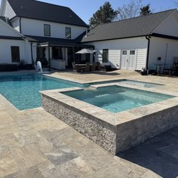 Another angle of L shaped pool with a clearer side view of the square spa