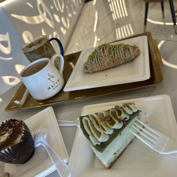 Matari Coffee - Tiramisu edible cup, pistachio cheesecake, pistachio croissant, pistachio ice latte, and a hot Yemeni tea w oat milk and honey - Coffee & Tea Near Me - Greenfield, Wisconsin Matari Coffee - Tiramisu edible cup, pistachio cheesecake, pistachio croissant, pistachio ice latte, and a hot Yemeni tea w oat milk and honey - Coffee & Tea Near Me - Greenfield, Wisconsin