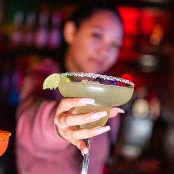 Burnhouse - a woman holding a margarita in a bar - Bars Near Me - San Antonio, Texas Burnhouse - a woman holding a margarita in a bar - Bars Near Me - San Antonio, Texas