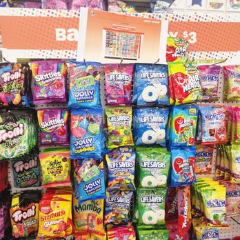 Five Below - Lol, no. So overpriced. - The image shows a retail store shelf stocked with assorted candies, including gummies, sour candies, and hard candies in colorful packaging. The candies are organized in rows, with brands like Skittles, Jolly Rancher, Life Savers, and Hi-Chew visible. The display is vibrant and designed to attract shoppers, with a sign at the top indicating pricing and product information. - Discount Store Near Me - Richmond, Virginia