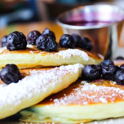 Midtown Cafe & Dessertery - Wild blueberry pancakes with tangy blueberries inside and out! Served with our house-made blueberry syrup.