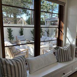 Patioworld - A view from inside showing the new outdoor patio furniture around a built-in firepit.