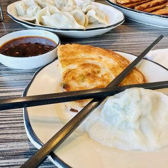 Meet Dumpling - a plate of dumplings with chopsticks - Chinese Near Me - San Diego, California