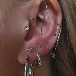 High Priestess Piercing & Tattoo - Total ear styling by Megan and Mya. We have a mix of jewelry from Modern Mood, Buddha Jewelry, and NeoMetal in white gold and titanium