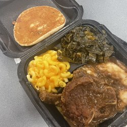Bungalow Restaurant - The smothered pork chop dinner with 2 Smothered Pork Chops, mashed potatoes, mac and cheese, and collard greens, and corn bread.
