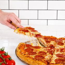 Cottage Inn Pizza Grosse Pointe Woods - That cheese pull says it all. Fresh, hot pepperoni pizza made to order at Cottage Inn Pizza in Grosse Pointe Woods.