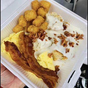 The Gravy Train - a person holding a container of food - Food Trucks Near Me The Gravy Train - a person holding a container of food - Food Trucks Near Me