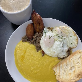 Breakfast In Havana - Picadillo Hash (Two fried eggs on top of picadillo(ground beef), with a side of yellow grits, small cuban toast and sweet plantains.) - Breakfast & Brunch Near Me - West Melbourne, Florida Breakfast In Havana - Picadillo Hash (Two fried eggs on top of picadillo(ground beef), with a side of yellow grits, small cuban toast and sweet plantains.) - Breakfast & Brunch Near Me - West Melbourne, Florida