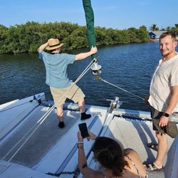 Island Time Marina - My daughter- in-laws brother hanging on to the sail with my son and Daughter in law.