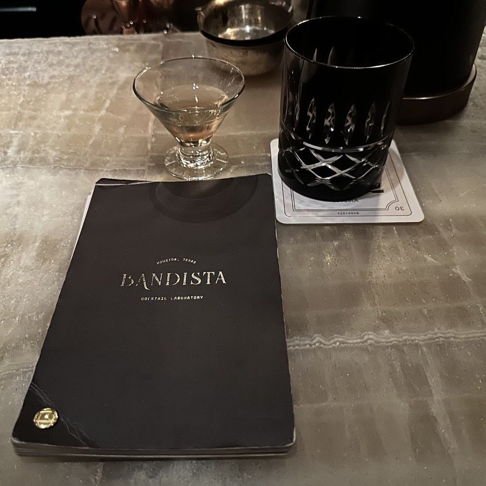 Bandista - Menu with complimentary welcome champagne and your choice of sparkling or still water - Cocktail Bars Near Me - Houston, Texas