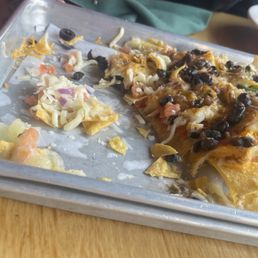 The cheese on the nachos was barely melted and clumped rather than fully melted and cohesive. The cheese on the nachos was barely melted and clumped rather than fully melted and cohesive.