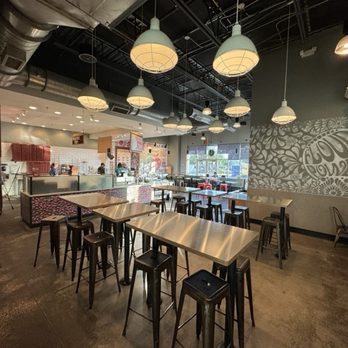 MOD Pizza - Part of the seating area, the kitchen, and ordering area. - Pizza Near Me - Orlando, Florida