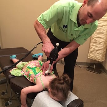 Stelios Spine and Health - Dr. Stelios adjusting a pediatric patient using the ArthroStim device - Chiropractors Near Me - Trinity, Florida Stelios Spine and Health - Dr. Stelios adjusting a pediatric patient using the ArthroStim device - Chiropractors Near Me - Trinity, Florida