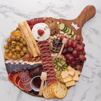 Crown Charcuterie - a platter of meat, cheese, crackers, grapes, and olives - Specialty Food Near Me Crown Charcuterie - a platter of meat, cheese, crackers, grapes, and olives - Specialty Food Near Me