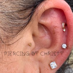 Rabbits Den Tattoo & Body Piercing Parlor - Helix with Yves dangle by Buddha Jewelry Organics and Tragus with triple bead by body gems. All solid gold.