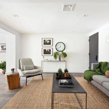 NJE Luxury - a living room with a sofa, coffee table, and a clock - General Contractors Near Me - Franklin Square, New York NJE Luxury - a living room with a sofa, coffee table, and a clock - General Contractors Near Me - Franklin Square, New York