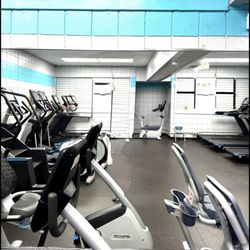 Mililani West Oahu YMCA - Fitness room with treadmills, bicycles, elliptical and stairs in air conditioning.