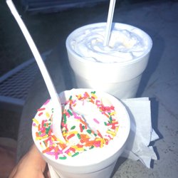 JJ's Soft Serve - Small cake batter flurry with rainbow sprinkles on top and a large snickers flurry