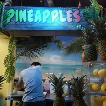 GiGi's PIZZA  -  man at a counter with pineapples - Pizza Near Me - Myrtle Beach, South Carolina
