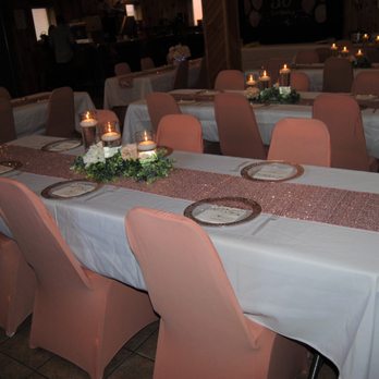 Making Memories Event Rentals - Seen here are our linens, runners, spandex chair covers, cylinder vases & greenery. In the background are floral centerpieces that we made. - Party Equipment Rentals Near Me Making Memories Event Rentals - Seen here are our linens, runners, spandex chair covers, cylinder vases & greenery. In the background are floral centerpieces that we made. - Party Equipment Rentals Near Me