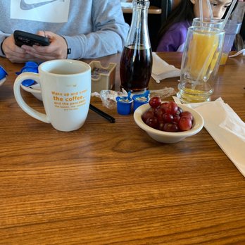 Denny's - a person sitting at a table with a cell phone - Diners Near Me - West Covina, California