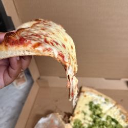 Dominick's Restaurant & Pizzeria - White pizza with broccoli and a plain slice