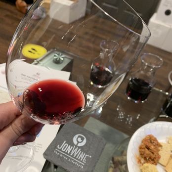 The Tasting Room - a person holding a glass of wine - Wine Bars Near Me - West Palm Beach, Florida The Tasting Room - a person holding a glass of wine - Wine Bars Near Me - West Palm Beach, Florida