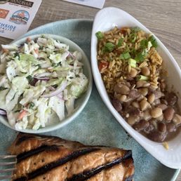 Grilled salmon with rice and beans and coleslaw. Grilled salmon with rice and beans and coleslaw.