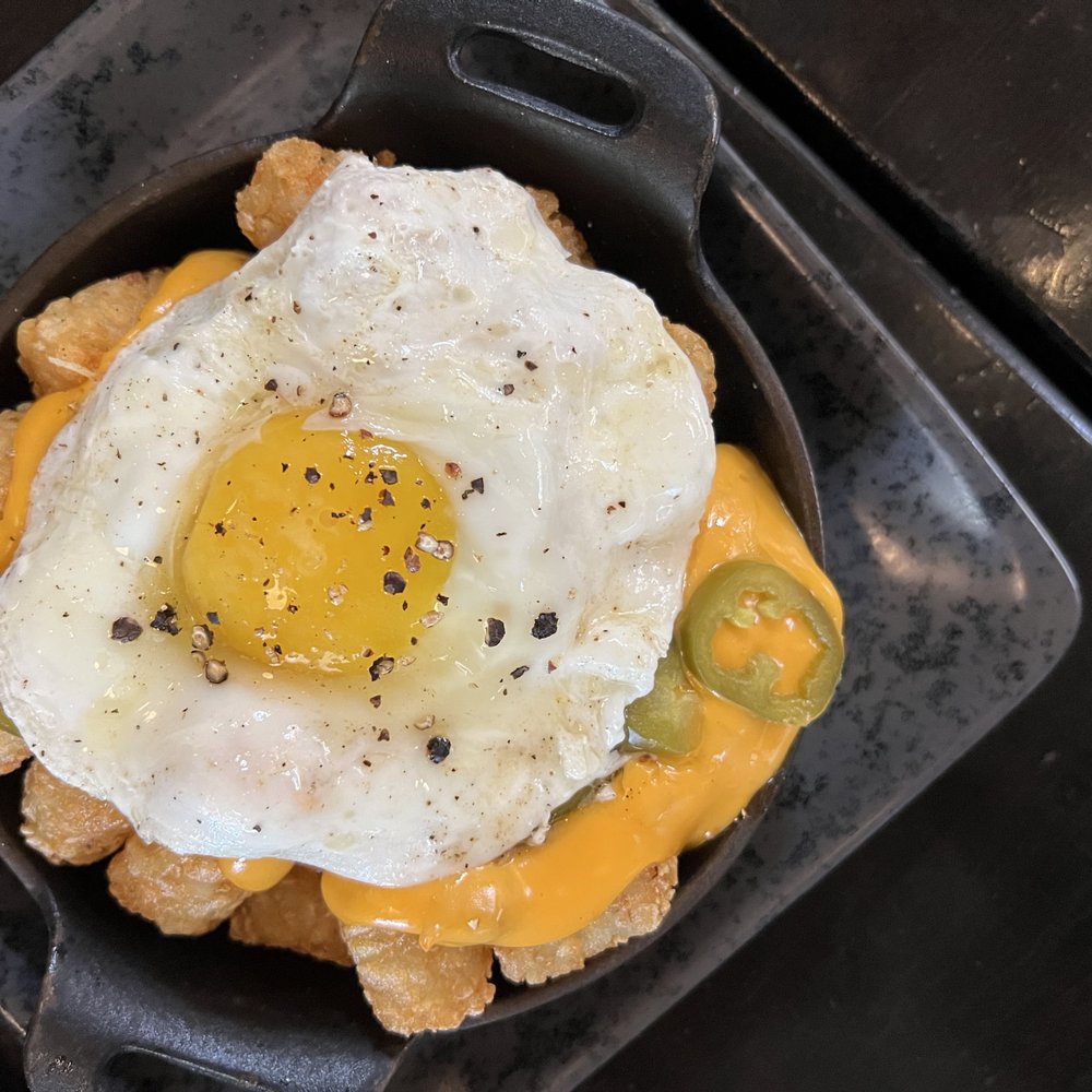 Bosscat Kitchen & Libations - totchos: tater tots, chorizo, jalapeños + fried egg = $12 - Bars Near Me - Orange, California Bosscat Kitchen & Libations - totchos: tater tots, chorizo, jalapeños + fried egg = $12 - Bars Near Me - Orange, California